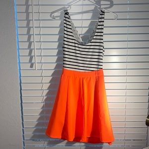 Fluorescent orange dress, crosses in back.